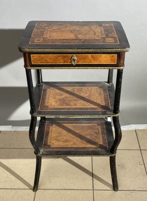 an old wooden table with three shelves on top of it