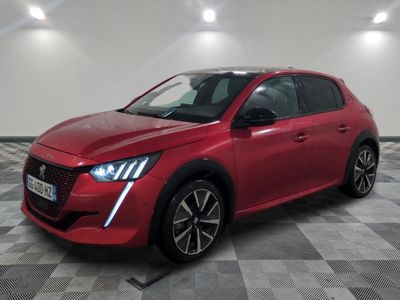 a red car parked on a checkered floor in a garage