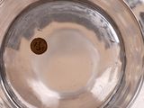 a close up of a glass of water with a penny in it