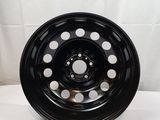 a close up of a black wheel on a white background