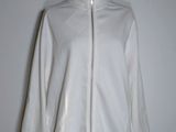 the white jacket is on a mannequin stand on a mannequin stand