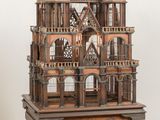 a wooden model of a castle sitting on a table