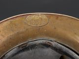 a close up of a hat with a gold emblem on it