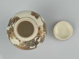 a vase and a bowl sitting on a table