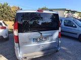 a silver van parked in a parking lot next to other cars