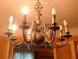 a chandelier that is hanging from the ceiling in the kitchen