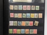 an open book with stamps on it sitting on top of a table