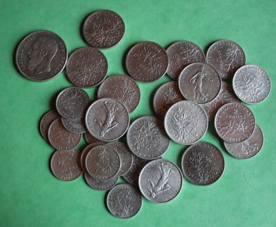 a lot of coins that are on a green surface