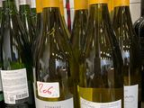 several bottles of wine are lined up on a counter