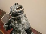 a statue of a bear holding a knife on a table