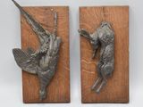pair of bronze birds mounted on wood blocks on a white background