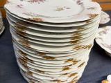 a lot of plates that are stacked up on a table