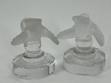 pair of clear glass candlestick holders on a white surface
