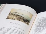 an open book with a picture of a lighthouse on it