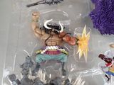 a toy figure of a man with a sword in a plastic container