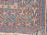 a blue and red rug with a pattern on it