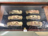 a lot of different types of knives in a display case