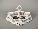 a picture of a porcelain tea set with cups and saucers