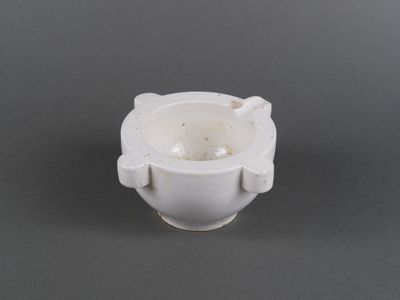 a white cup that is sitting on a table