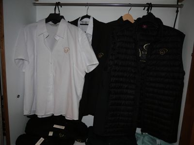 two shirts hanging on a rack in a closet