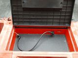 a red tool box with a power cord in it