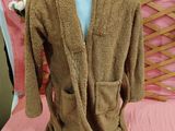 a brown robe on a mannequin on a bed