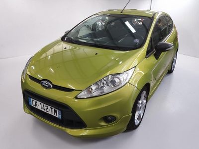 a green car that is parked in a white room