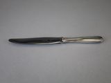 a black and silver pen sitting on top of a white table