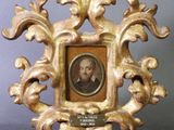 un cadre ancien contenant le portrait d'un homme, dans un cadre doré