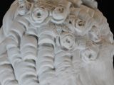 a white statue of a woman with a hat on her head