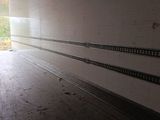 an image of a long empty room with a sliding door