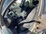 the interior of a car with the door open and the driver ' s seat up