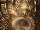 a close up of a gold vase with a decorative design