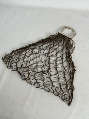 a net bag with a handle on a white surface