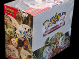a box of pokemon trading cards on a black background