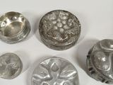 a lot of silver objects on a white surface