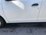 a small white car parked on the side of the road