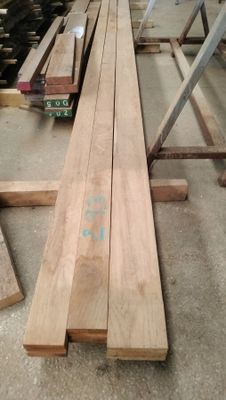 several pieces of wood are stacked on top of each other in a warehouse