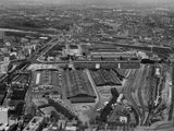 an aerial view of a city with a train station and train tracks