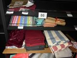 a shelf with many different types of fabric on it