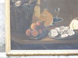 painting of a still life of oysters, peaches, and bread on a table