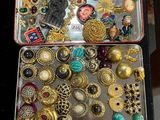 many different types of jewelry in a metal case