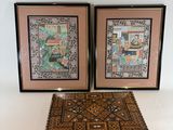 two framed pictures of a couple of wooden boxes sitting on a table