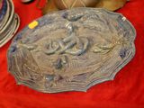 a plate with a fish design on it on a red table