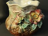 a vase that has a flower on it on a table