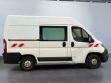 a white van with red stripes parked in a garage