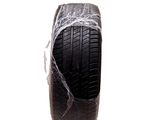 a piece of plastic wrapped around a tire on a white background