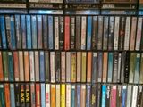a lot of dvds stacked on a shelf in a room