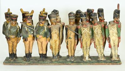 a group of toy soldiers that are standing in a row