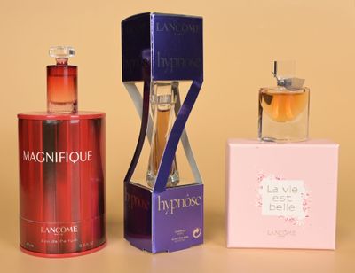bottles of perfume and a box of perfume on a table